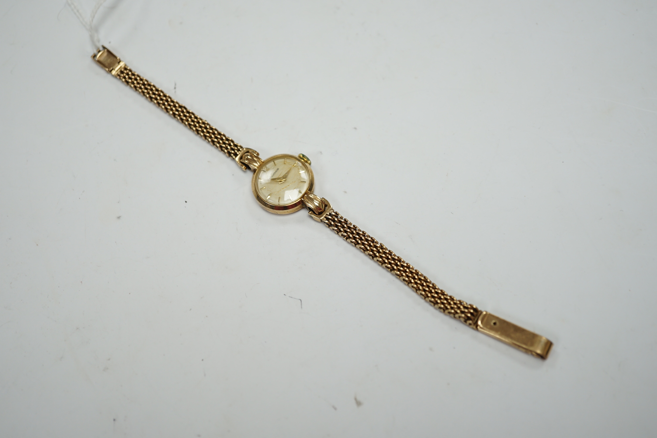 A lady's 9ct gold Jaeger LeCoultre manual wind wrist watch, on an associated 9ct gold bracelet, overall 16.8cm, gross weight 20.4 grams.